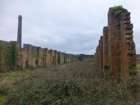 View from inside the remains of the former nitric acid factory to its chimney (the chimney is listed at Grade II)
